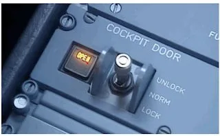 Cockpit door control panel showing a lit OPEN light and a switch set between unlock, norm and lock
