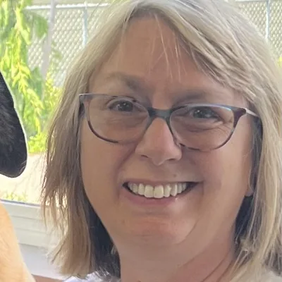 Jane Block, a smiling woman with shoulder-length blonde hair and glasses.