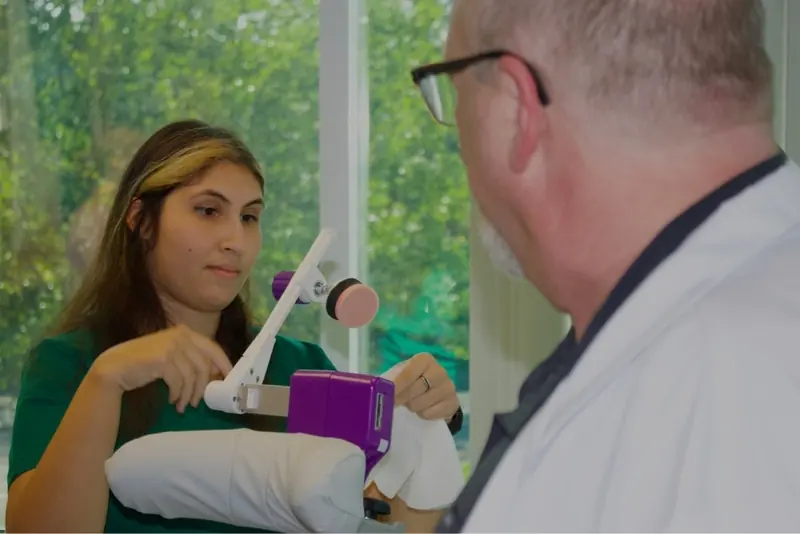 A smiling patient giving a thumbs up during a TMS session at Diamond Edge TMS in Vancouver, WA