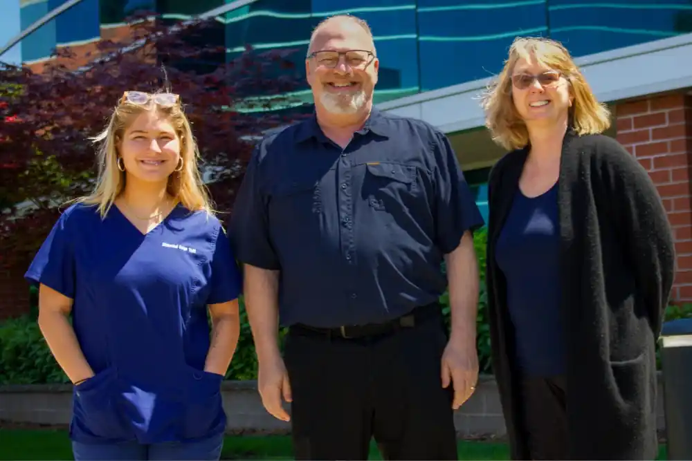 The Diamond Edge TMS team of three standing outside their Vancouver, WA clinic.